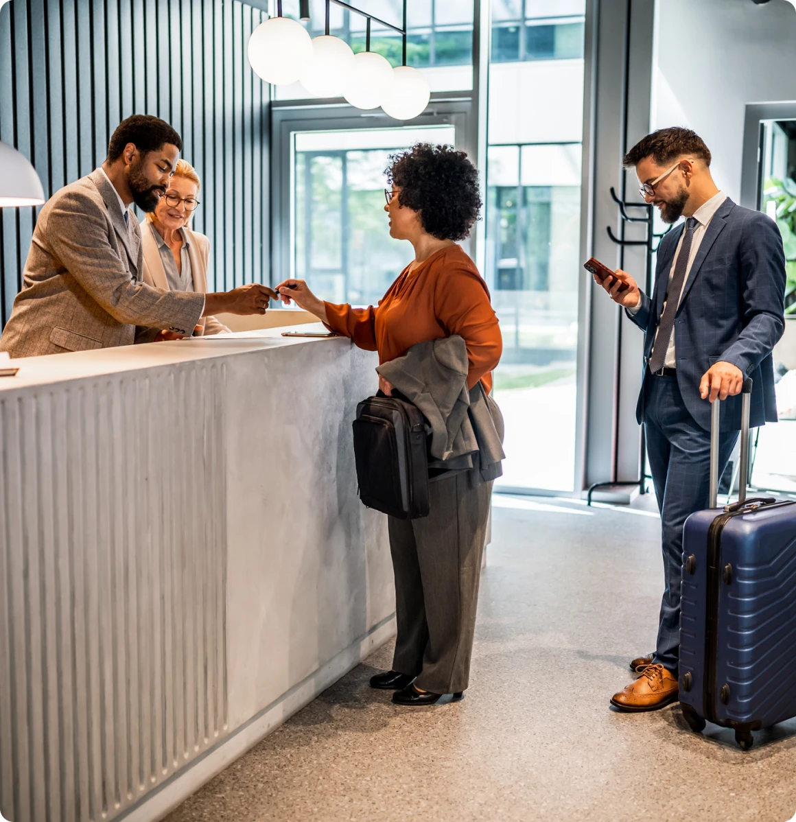 Business travelers completing check-in at counter
